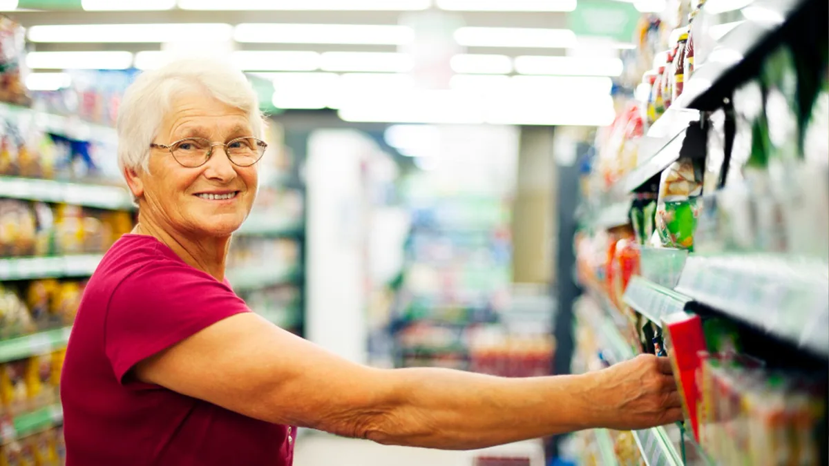 A care professional helping an older woman at home